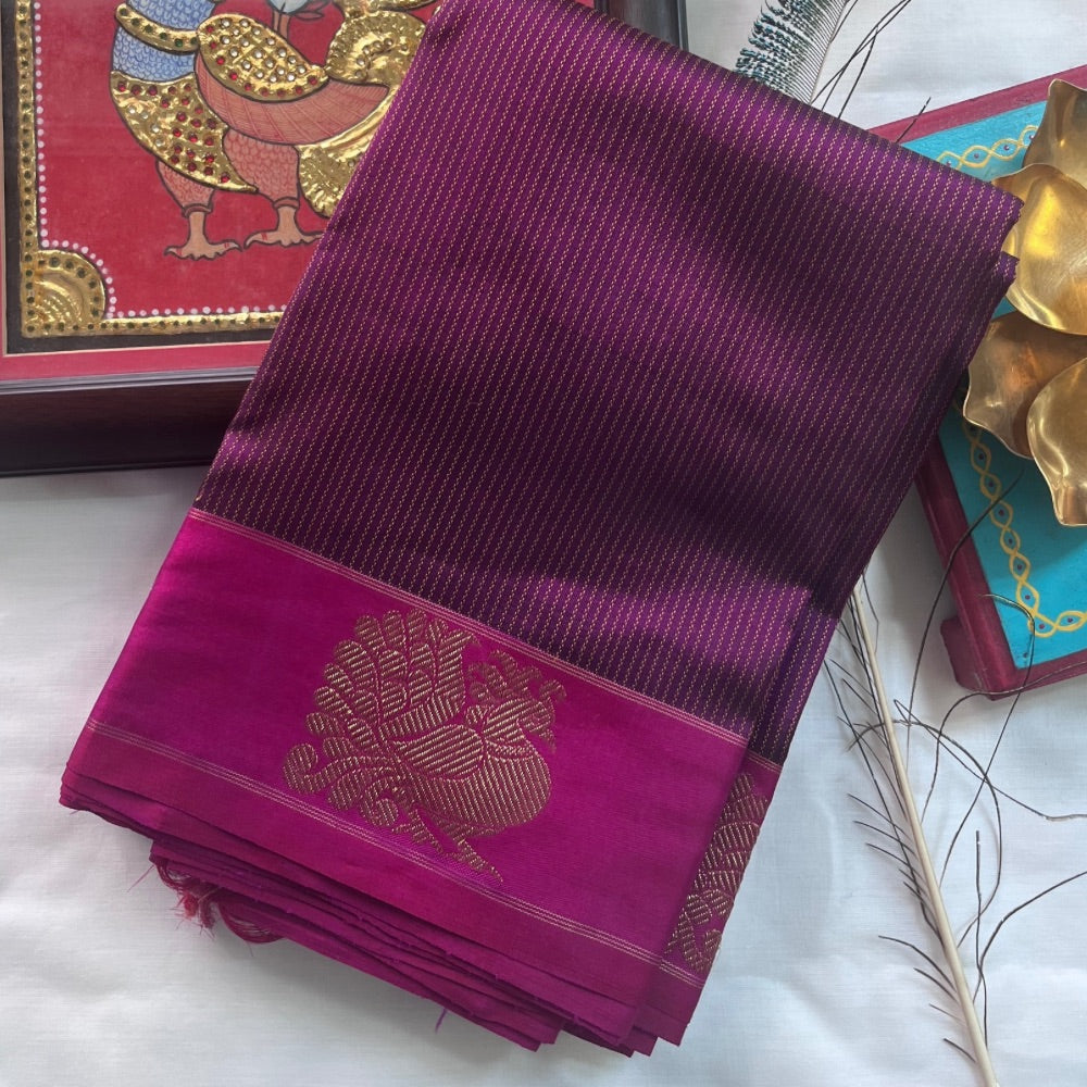 Deep maroon with pink border and zari pallu with Mayil chankram motif on border
